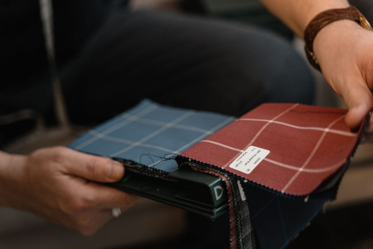 Fabric swatch books being compared by hand