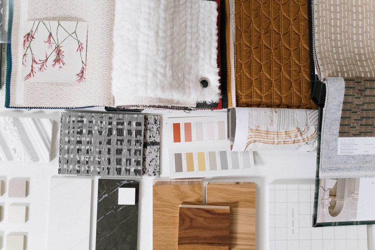 Fabric swatches, trimmings and a colour palette laid out on a table
