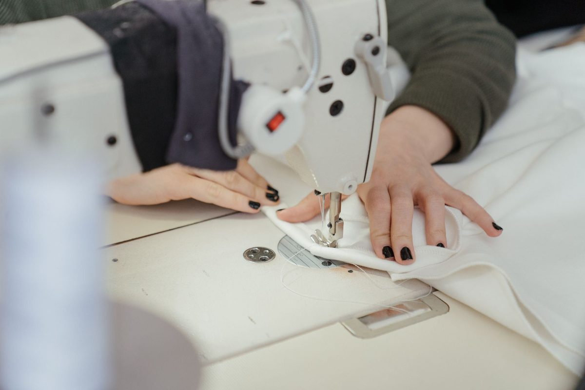 Curtain fabric being stitched on a workroom machine